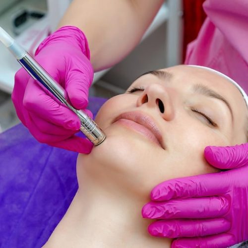 carrying-out-rf-lifting-procedure-beauty-salon-woman-face-skin-cleansing-oval-face_137416-3642